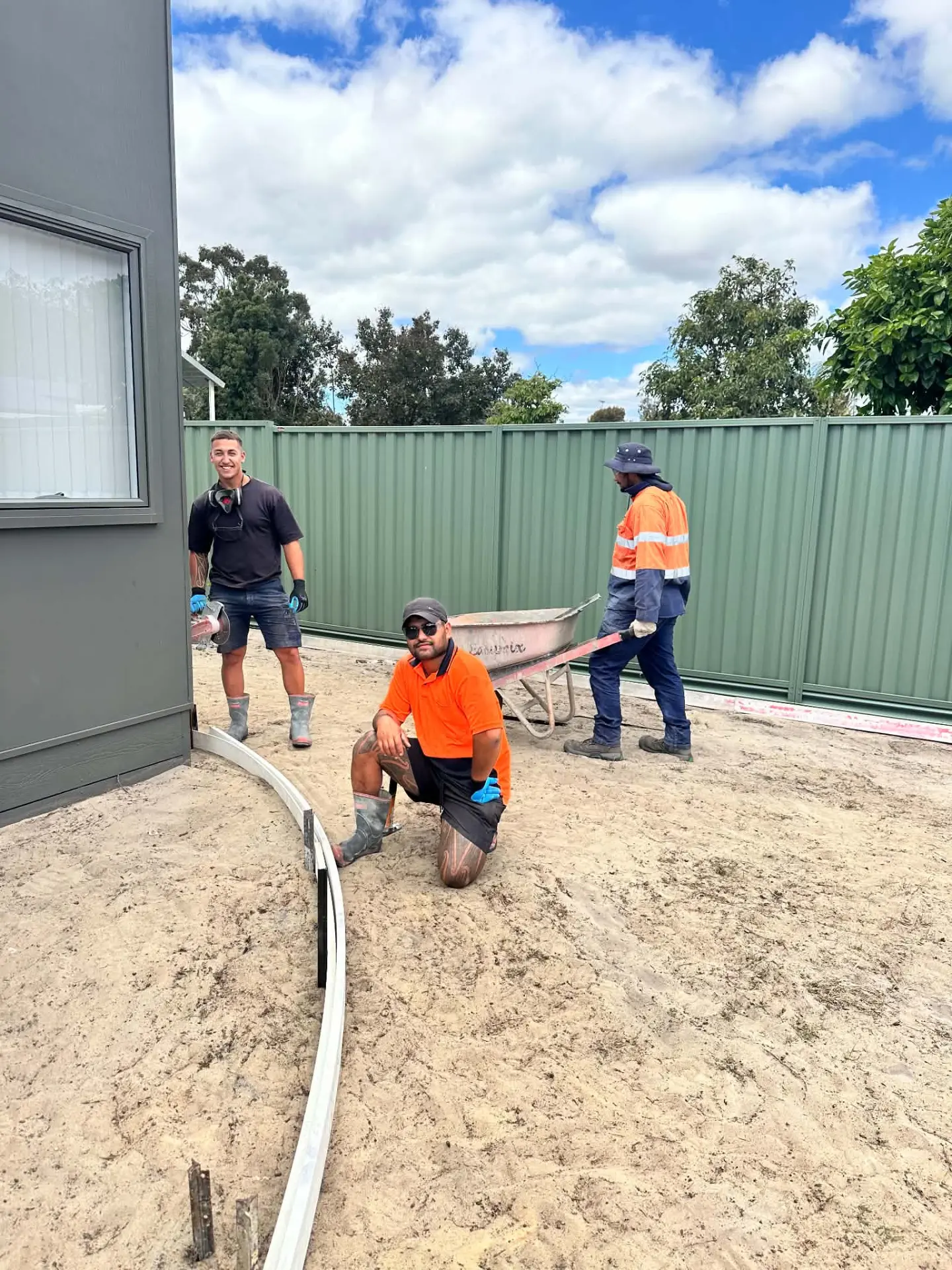 Trey (centre, orange shirt) with the True Level Concrete crew on site